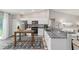 Bright kitchen featuring stainless steel appliances, white cabinets, granite counters and a wooden kitchen island at 204 Emerald Loop Way, Ocala, FL 34472