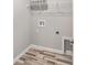 Laundry room with modern wood floors and utility connections, ready for appliances at 204 Emerald Loop Way, Ocala, FL 34472