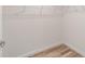 Walk-in closet with wooden floors and wire shelving, offering ample storage space at 204 Emerald Loop Way, Ocala, FL 34472