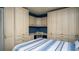 Cozy bedroom with built-in desk, cabinets and a bed with blue striped comforter at 20820 River Dr # B25, Dunnellon, FL 34431