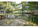 Relax on the spacious deck with serene views of the waterway and lush foliage at 20820 River Dr # B25, Dunnellon, FL 34431