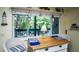 Bright dining area features a large window offering outdoor views and a cozy setup at 20820 River Dr # B25, Dunnellon, FL 34431