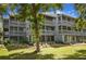 Charming condo building featuring multiple screened-in porches and balconies nestled in a green, landscaped setting at 20820 River Dr # B25, Dunnellon, FL 34431