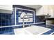 Kitchen featuring a nautical themed tile backsplash, updated sink faucet and white cabinets at 20820 River Dr # B25, Dunnellon, FL 34431