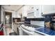Bright kitchen featuring blue tile backsplash, modern appliances, and in-unit laundry at 20820 River Dr # B25, Dunnellon, FL 34431