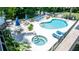 Community pool and spa surrounded by manicured landscaping and with lake views at 20820 River Dr # B25, Dunnellon, FL 34431