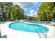 Inviting community pool area with comfortable lounge chairs and shaded umbrellas near the lake at 20820 River Dr # B25, Dunnellon, FL 34431