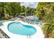 Enjoy poolside relaxation with lake views, a perfect spot for leisure and recreation at 20820 River Dr # B25, Dunnellon, FL 34431