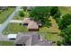 Aerial view of the home's roof and surrounding neighborhood, with the backyard and large trees at 21425 Sw Plantation St, Dunnellon, FL 34431