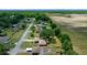 Aerial view of a residential street near a rural field, highlighting the community's peaceful setting at 21425 Sw Plantation St, Dunnellon, FL 34431