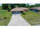 Aerial view of a single Gathering home on a large lot with a long driveway at 21425 Sw Plantation St, Dunnellon, FL 34431