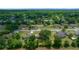 An aerial view of homes surrounded by lush green trees in a peaceful neighborhood setting at 21425 Sw Plantation St, Dunnellon, FL 34431