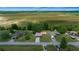 An aerial view showcases a neighborhood with well-spaced homes and expansive green agricultural space beyond at 21425 Sw Plantation St, Dunnellon, FL 34431