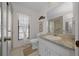 Well-lit bathroom with white cabinets, granite countertop, and shower with glass door at 21425 Sw Plantation St, Dunnellon, FL 34431