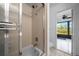 Bathroom features a shower with glass door and view to the outside at 21425 Sw Plantation St, Dunnellon, FL 34431