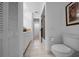 Bright bathroom features a shower, toilet, and tile flooring at 21425 Sw Plantation St, Dunnellon, FL 34431