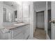 Bathroom vanity with white cabinets, granite countertop, and a mosaic backsplash at 21425 Sw Plantation St, Dunnellon, FL 34431