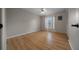 Light-filled bedroom features wood floors, closet, and large window with curtains for privacy and natural light at 21425 Sw Plantation St, Dunnellon, FL 34431