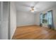 Bedroom features light wood flooring, neutral walls, and a window with natural light at 21425 Sw Plantation St, Dunnellon, FL 34431