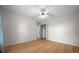 Light-filled bedroom showcases wood floors, a ceiling fan, and a closet with ample shelving at 21425 Sw Plantation St, Dunnellon, FL 34431