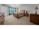 Cozy bedroom with plush carpet, a ceiling fan, and ample natural light at 21425 Sw Plantation St, Dunnellon, FL 34431