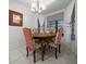 Dining room featuring a chandelier, tile flooring, and a wood dining table with upholstered chairs at 21425 Sw Plantation St, Dunnellon, FL 34431