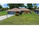 Charming single-story home with a well-maintained lawn and inviting curb appeal at 21425 Sw Plantation St, Dunnellon, FL 34431