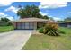 Charming single-story home featuring a stone accent garage and well-maintained front yard landscaping at 21425 Sw Plantation St, Dunnellon, FL 34431