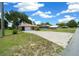 Wide view of this single-story home showcasing its spacious lot and charming exterior from the street at 21425 Sw Plantation St, Dunnellon, FL 34431