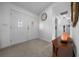 Welcoming foyer with double doors, decorative mirror, and table offers seamless transition to living spaces at 21425 Sw Plantation St, Dunnellon, FL 34431