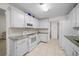 Bright kitchen with white cabinets, granite countertops, and stainless steel appliances at 21425 Sw Plantation St, Dunnellon, FL 34431