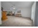 The living room is carpeted and has a ceiling fan, as well as furniture, and direct access to the backyard at 21425 Sw Plantation St, Dunnellon, FL 34431