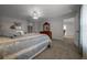 Primary bedroom features a ceiling fan, ensuite bathroom, walk in closet, and carpeted floor at 21425 Sw Plantation St, Dunnellon, FL 34431