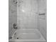 This bathroom has a tub with a shower and a white tile surround at 235 Locust Pass Ln, Ocala, FL 34472