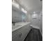 Bathroom featuring double sink vanity, modern lighting, and tiled shower at 235 Locust Pass Ln, Ocala, FL 34472