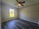 Bedroom with hard surface floors, neutral walls, and an updated ceiling fan with light fixture at 235 Locust Pass Ln, Ocala, FL 34472