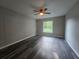 This bedroom features a ceiling fan and a window with a view of the outdoors at 235 Locust Pass Ln, Ocala, FL 34472