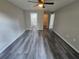 Large bedroom with multiple doorways and light-colored walls over dark modern flooring at 235 Locust Pass Ln, Ocala, FL 34472