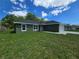 Charming home featuring an attached two-car garage and a well-maintained lawn at 235 Locust Pass Ln, Ocala, FL 34472