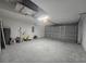 Spacious garage with concrete floor and an insulated garage door at 235 Locust Pass Ln, Ocala, FL 34472