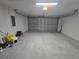View of the garage of the home including a work area and an open garage door at 235 Locust Pass Ln, Ocala, FL 34472