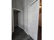 Hallway with grey walls and modern flooring, showcasing doorways to other rooms at 235 Locust Pass Ln, Ocala, FL 34472