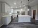 Modern kitchen with white cabinets, stainless steel appliances, and marble countertops at 235 Locust Pass Ln, Ocala, FL 34472