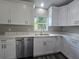 Kitchen featuring white cabinets, stainless steel appliances, and ample counter space at 235 Locust Pass Ln, Ocala, FL 34472