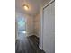 Pass through laundry room with a hall closet and dark wood floors at 235 Locust Pass Ln, Ocala, FL 34472