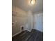 Functional laundry room with overhead shelving, hookups, and a door to the outside at 235 Locust Pass Ln, Ocala, FL 34472