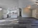 This living room features an open floor plan with a kitchen island, white cabinets, and stainless steel appliances at 235 Locust Pass Ln, Ocala, FL 34472