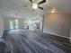 Spacious living room with open layout into the kitchen, featuring modern finishes at 235 Locust Pass Ln, Ocala, FL 34472