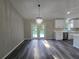 This living room has white cabinets, modern light fixtures, and french doors leading to the outdoors at 235 Locust Pass Ln, Ocala, FL 34472