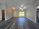 Open living space with wood-look floors and natural light, next to the kitchen at 235 Locust Pass Ln, Ocala, FL 34472